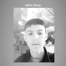 a black and white photo of a man with the words adam olmus above him