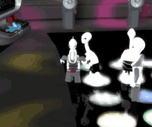 three lego figures are dancing in front of a computer