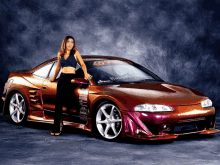 a woman standing next to a car that says lg on the front