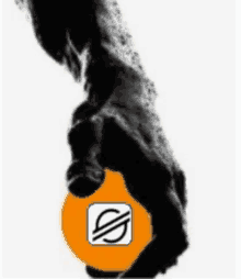 a black and white photo of a hand holding an orange ball with a s on it