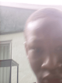 a blurry picture of a person 's face with a blurred background