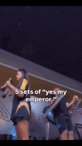 a woman holding a microphone with the words " 5 sets of " yes my emperor " on it