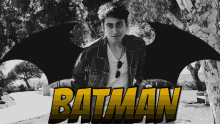 a black and white photo of a young man with the word batman in yellow