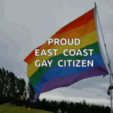 a rainbow flag with the words " proud east coast gay citizen " on it