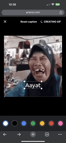 a phone screen shows a picture of a woman laughing with the caption aayat