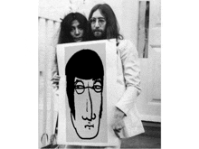 a man and a woman holding a drawing of a man 's face