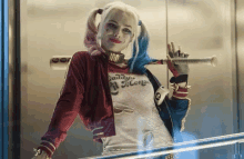 harley quinn is holding a bat in an elevator .