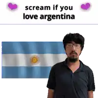 a man with glasses is standing in front of an argentina flag