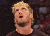 a man with blonde hair and a beard is looking up at something