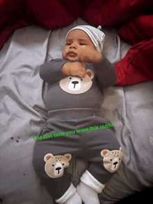 a baby is wearing a teddy bear outfit and a hat