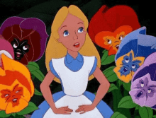 alice from alice in wonderland is surrounded by flowers with different faces on them .