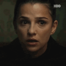 a close up of a woman 's face with a surprised expression .