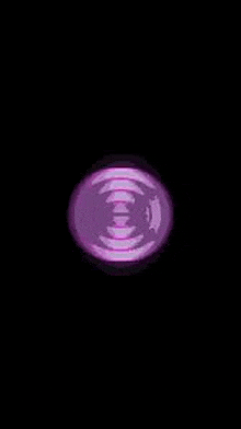 a purple circle is floating in the air on a black background