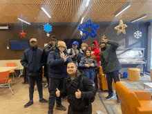 a group of people are posing for a picture in a living room .