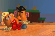 mr. potato head and mrs. potato head from toy story are on a wooden table