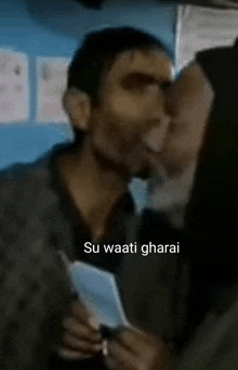 a man kissing a woman with the words su waati gharai on the bottom right