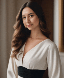 a woman wearing a white and black dress with a black belt