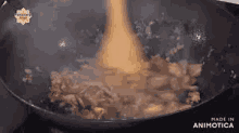 a pan of food is being cooked on a stove with a spatula .