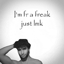 a shirtless man with ear buds holds his hand to his head with the words i 'm fra freak just imk below