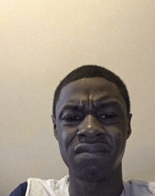 a young man is making a funny face with his mouth open .