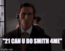 a man in a suit and tie is wearing headphones and saying ' 21 can u do smith 4 me '