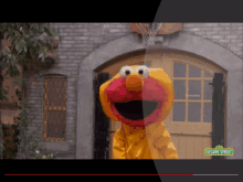 elmo from sesame street is standing in front of a garage