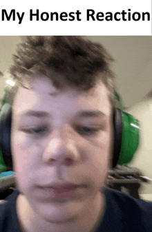 a blurry picture of a boy with headphones and the words my honest reaction above him