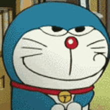 a close up of a cartoon character , doraemon , with a red nose and a bell around his neck .