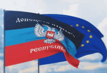 a red and blue flag with a coat of arms and the word donetsk on it