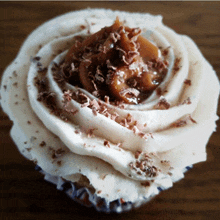 a cupcake with frosting and chocolate shavings on it