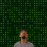 a man stands in front of a green background with the number 21