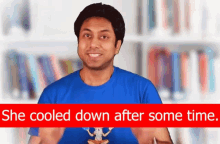 a man in a blue shirt is standing in front of a bookshelf with the words she cooled down after some time