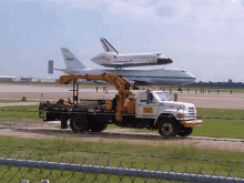 a united states space shuttle is on the runway