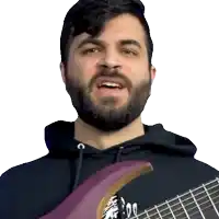 a man with a beard is singing while holding a guitar