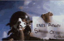 a man in a helmet holding a sign that says enes on it