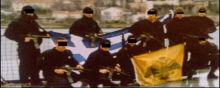 a group of soldiers with their faces obscured holding a flag