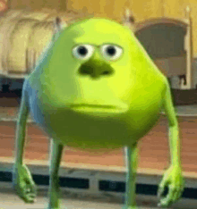 mike wazowski from monsters inc is standing in front of a bed in a bedroom .