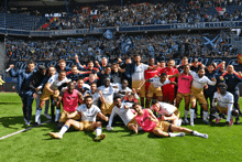 a group of soccer players are posing for a photo on the field