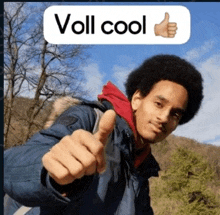 a young man giving a thumbs up with a sign that says voll cool above him