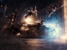 a group of justice league characters are flying through the air in a dark scene