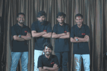 a group of men are posing for a picture with their arms crossed and their shirts saying ' netflix '