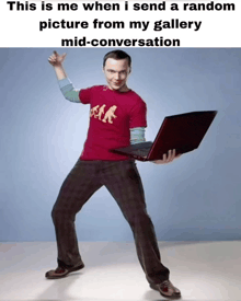 a man in a red shirt is holding a laptop in his hands