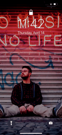 a phone screen shows a man sitting in front of a sign that says " no life "