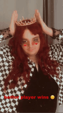 a woman with red hair wearing a crown and a checkered jacket