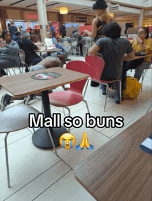 a man sits at a table with the words mall so buns on the bottom