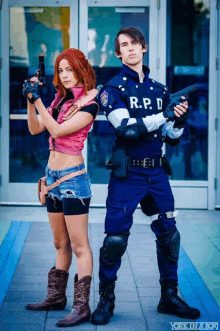 a man in a r.p.d. uniform stands next to a woman holding guns