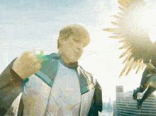 a man in a superhero costume is holding a green object