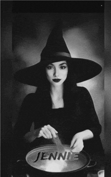 a black and white photo of a woman in a witch costume with jennie written on a pot