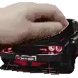 a close up of a person 's hand holding a car .