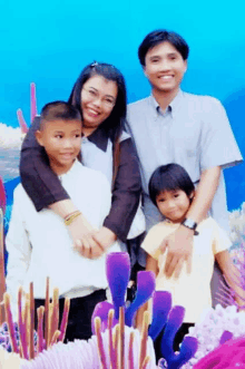 a family posing for a picture in front of a blue background